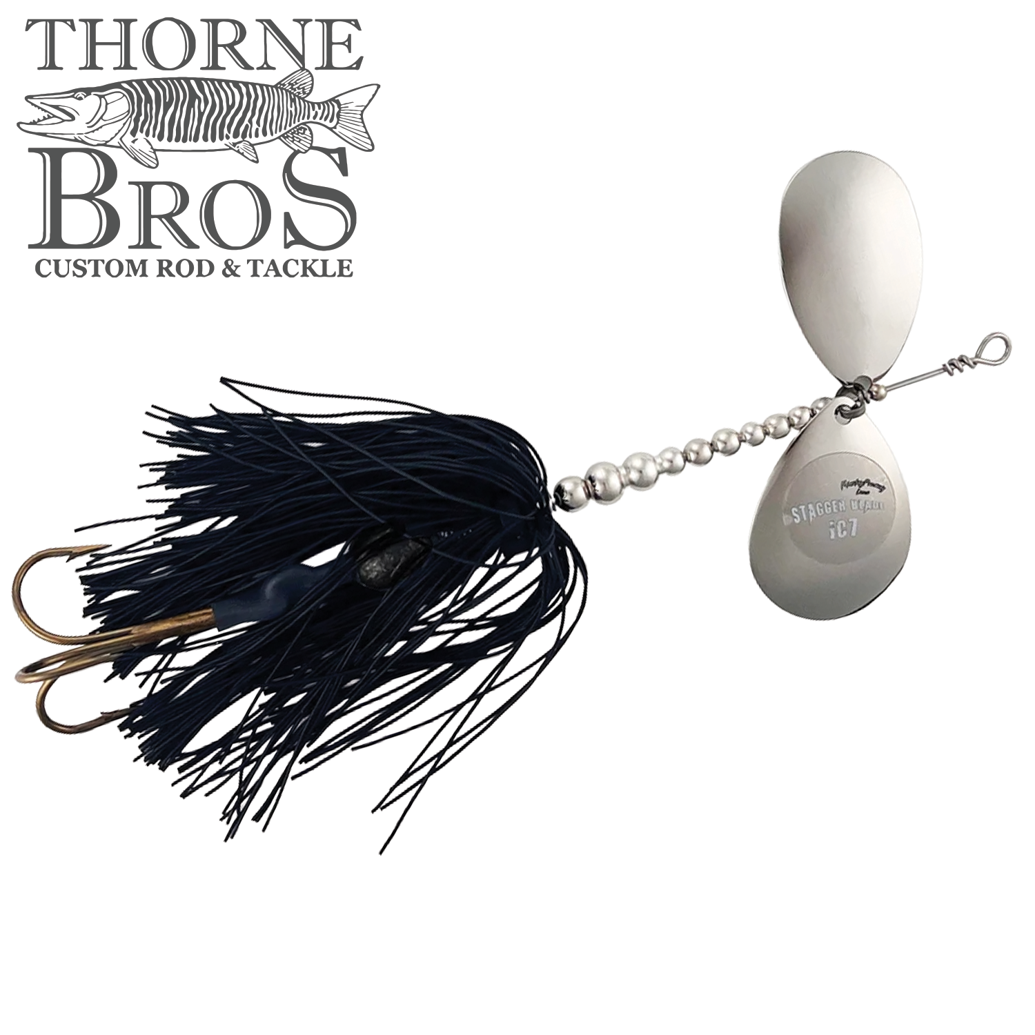 Musky Frenzy Apache Stag IC7 spinnerbait fishing lure with dual silver blades, metal beaded body, and black skirted treble hooks for musky fishing.