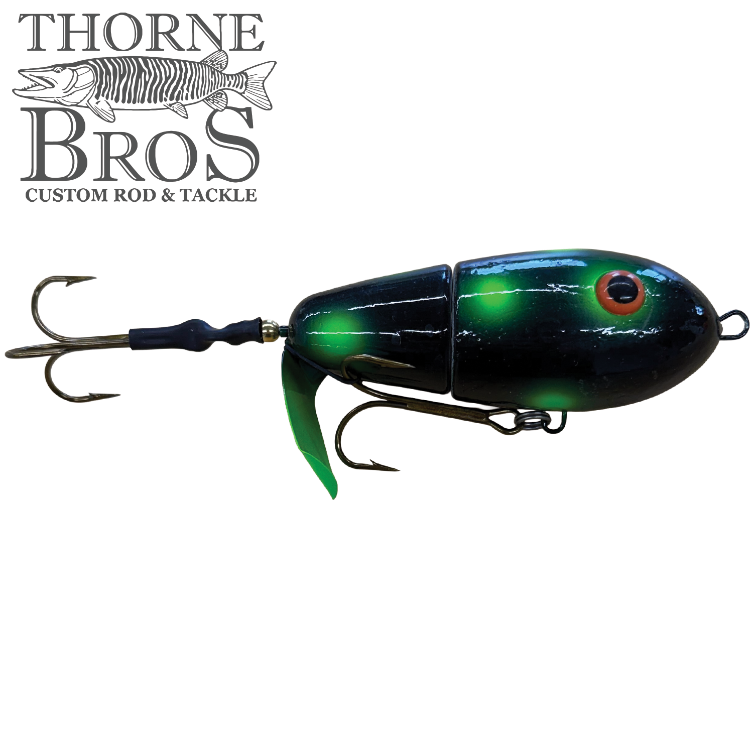 Lake-X Fat Bastard fishing lure with segmented black and green body, detailed eyes, and two treble hooks designed for musky fishing.