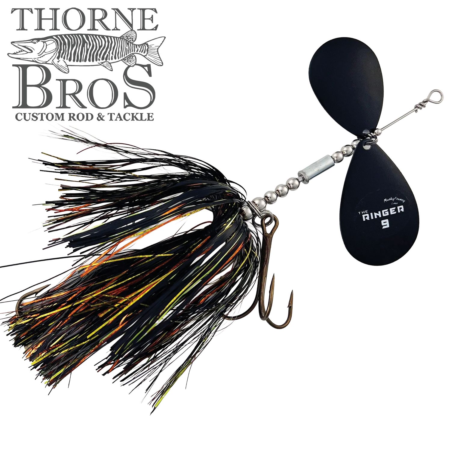 Close-up of the Musky Frenzy The Ringer 9 fishing lure featuring black and orange skirt strands, a treble hook, and two black spinning blades designed for musky fishing tackle.