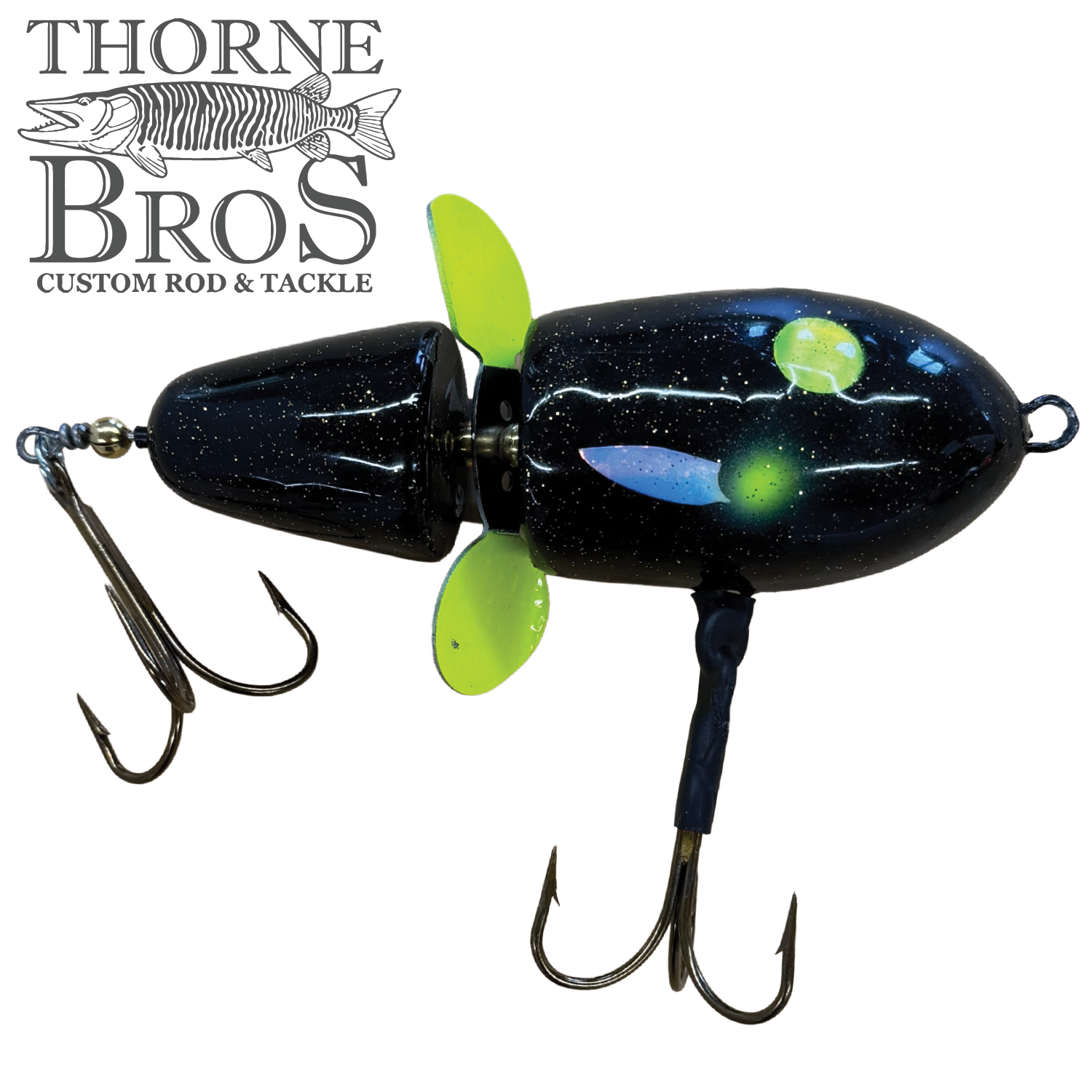 Thorne Bros Lake-X Hammer fishing lure in black with green and yellow accents, featuring two treble hooks and a propeller for musky fishing tackle.