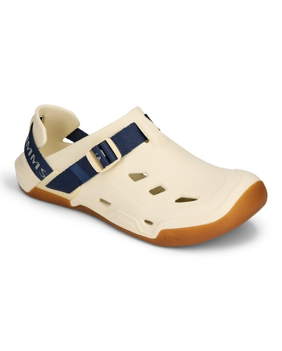 Simms Drifter lightweight beige fishing sandal with adjustable navy blue strap, ventilation cutouts, and gum rubber sole designed for water and outdoor use.