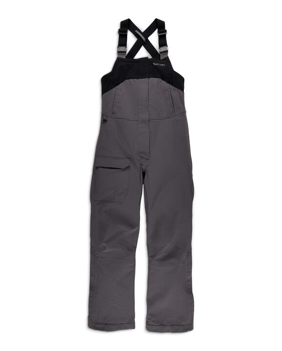 Simms W's Challenger Rain Bib designed for fishing, featuring adjustable black shoulder straps, durable gray waterproof fabric, multiple pockets, and reinforced knees for outdoor use.