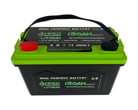 Amped Outdoors 130Ah Dual Purpose Lithium Battery (Cranking) 12.8V - Bluetooth enabled with IP67 waterproof rating and heated design, featuring green and black casing with red and black terminals.