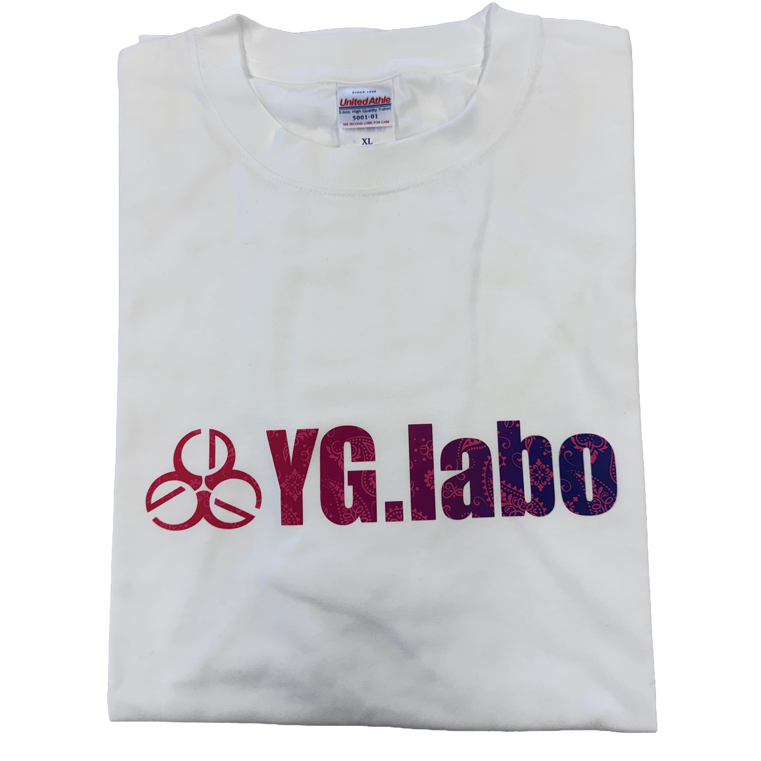 Folded white YG.Labo T-Shirts with a logo featuring stylized text in shades of red and blue on the front, displayed against a plain background.