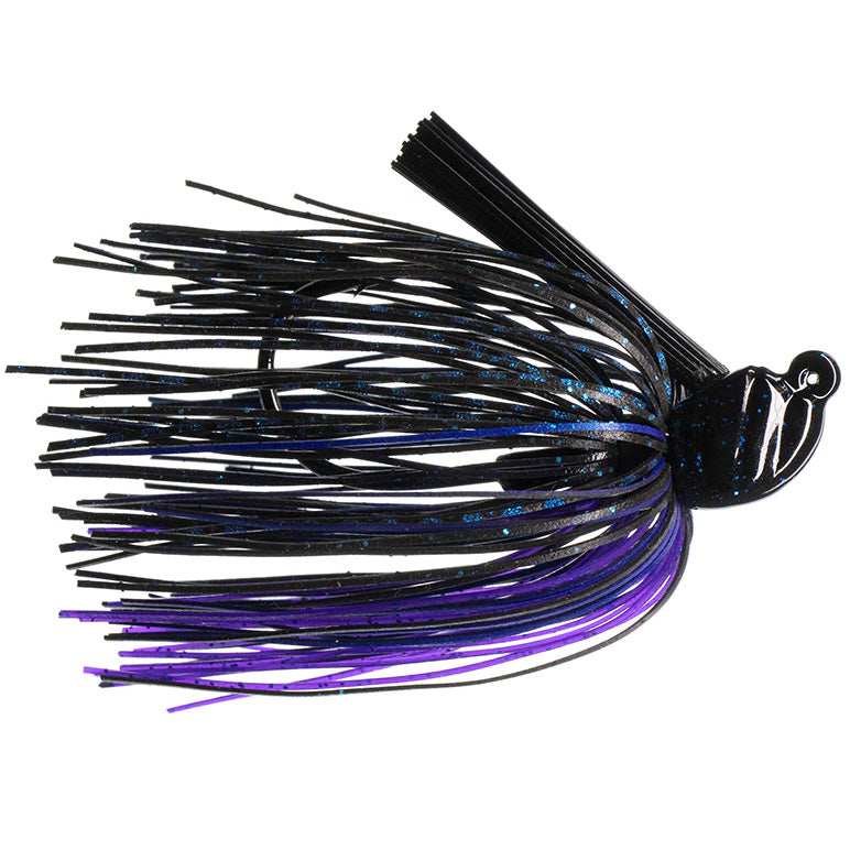 Dirty Jigs Scott Canterbury Flippin Jig in black and purple with blue speckles, featuring a detailed jig head and flexible skirt strands designed for fishing tackle use.