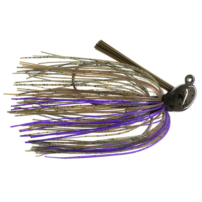 Dirty Jigs Luke Clausen Casting Jig with a weighted, dark-colored head and a skirt of beige and purple strands with black flecks designed for musky fishing tackle.