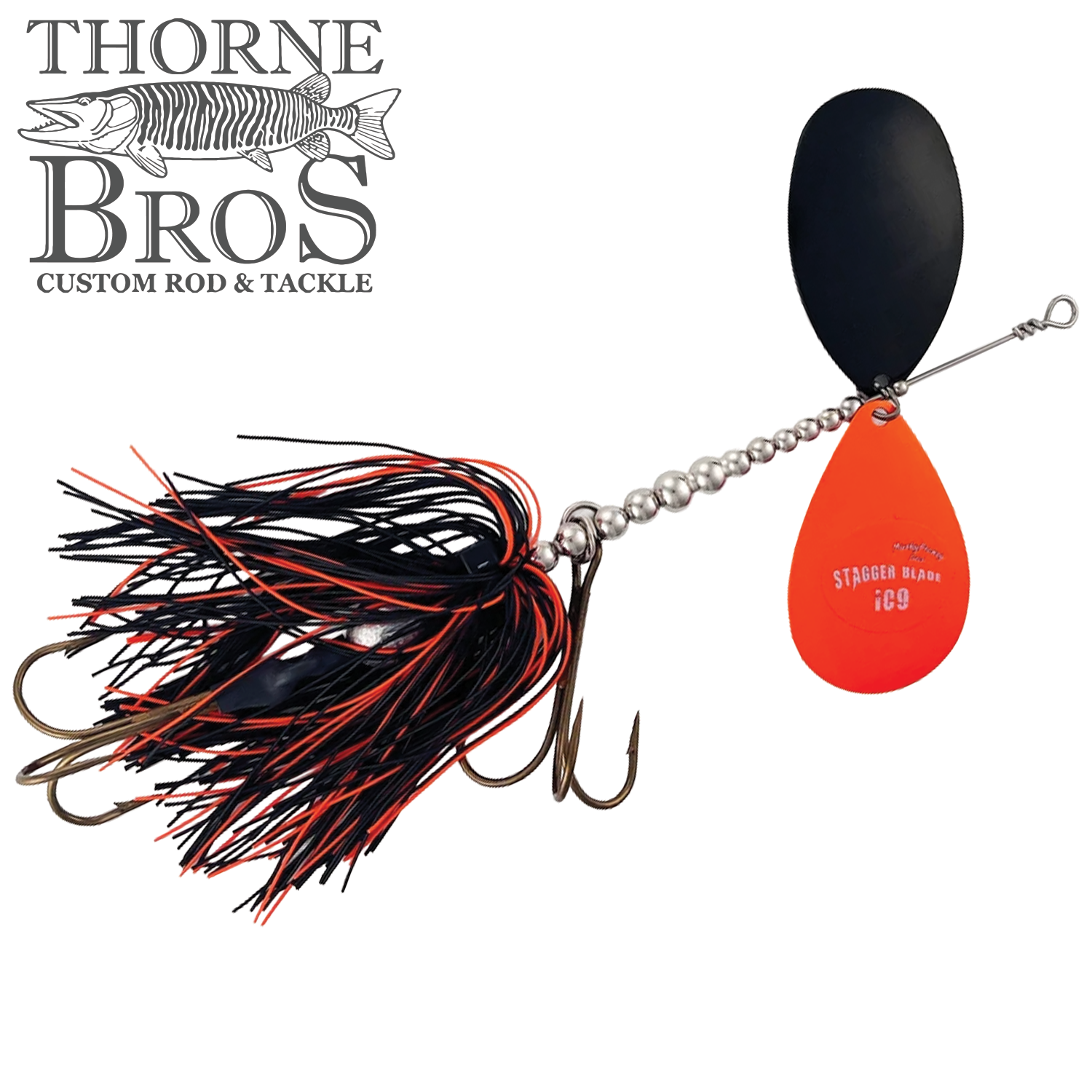 Musky Frenzy Apache Stag IC9 fishing lure with black and orange skirt, silver beaded wire, two hooks, and dual spinner blades designed for musky fishing.
