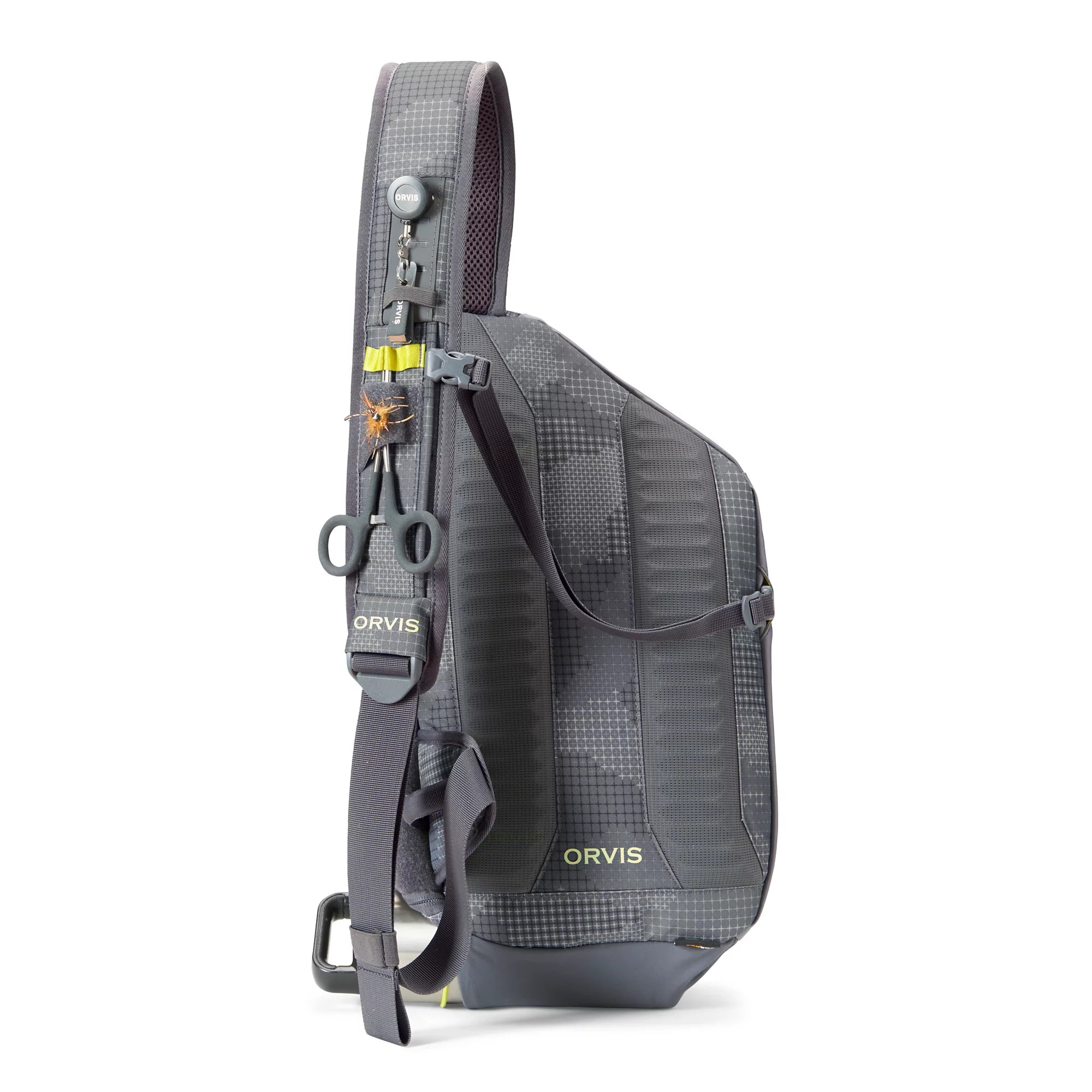 Orvis Sling Pack in dark gray featuring a single padded shoulder strap with clips, loops, and attachments for fishing tools, designed for lightweight fishing tackle organization.