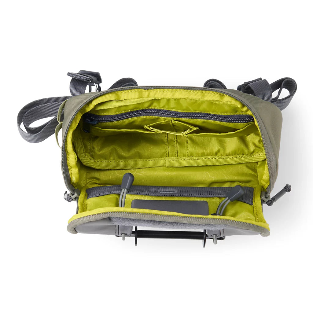 Orvis Chest/Hip Pack shown open with lime green lined compartments zippered pockets adjustable straps and organized storage for fishing tackle