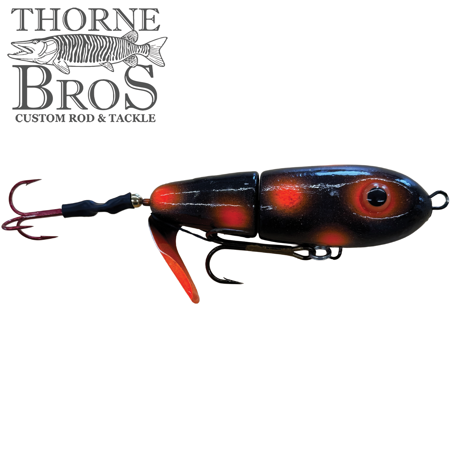 Lake-X Dr. Evil fishing lure with segmented black and red body, two treble hooks, and a metal spinner blade designed for musky fishing.
