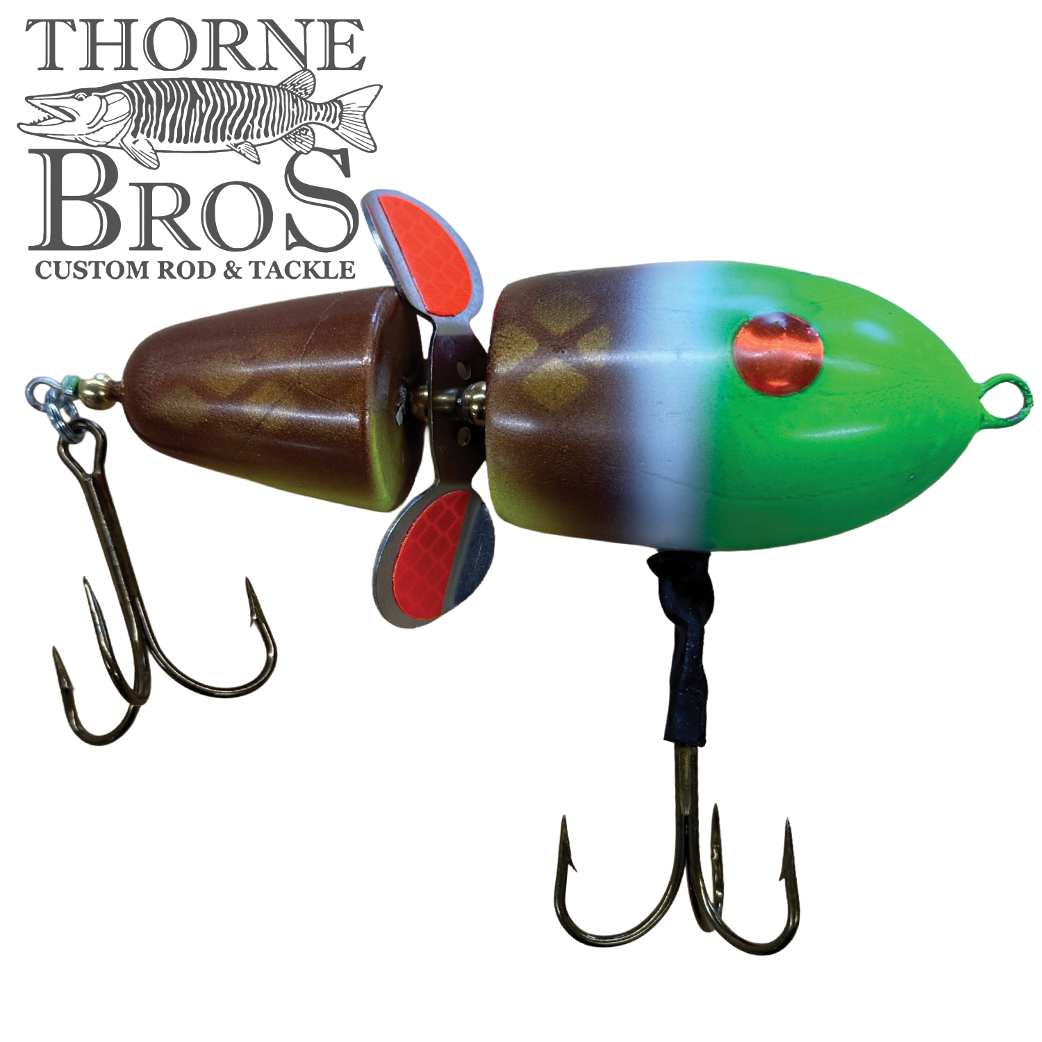 Lake-X Hammer fishing lure with segmented brown and green body, red eye detail, dual treble hooks, and red and black spinner blades for musky fishing tackle.