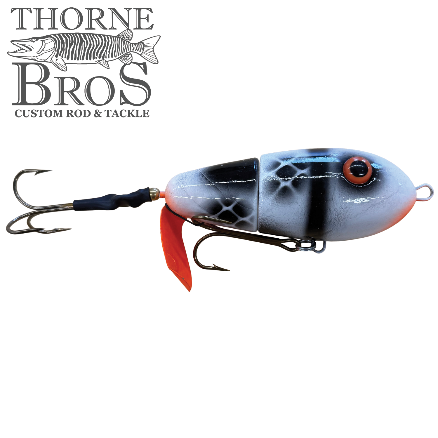 Lake-X Fat Bastard fishing lure in black, white, and red colors with detailed fish scale pattern, two treble hooks, designed for musky fishing tackle.