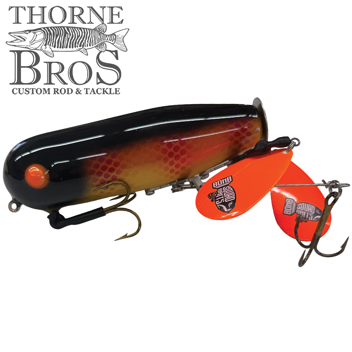 Bomb Squad Double Tap Flap Tail fishing lure in black, red, and orange tones with two treble hooks and dual bright orange flap tail blades for musky fishing tackle.
