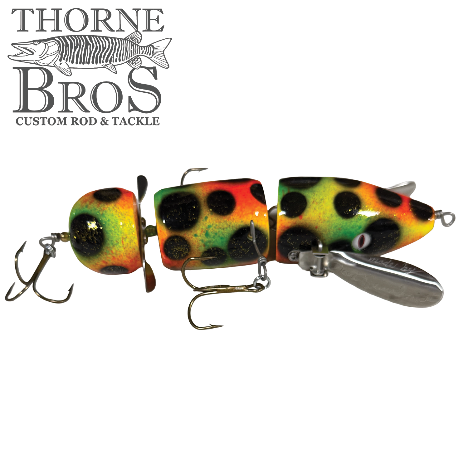 Musky Safari Franken Spitz fishing lure in vibrant yellow, orange, and green with black spots, featuring multiple treble hooks and metal propeller for musky fishing.