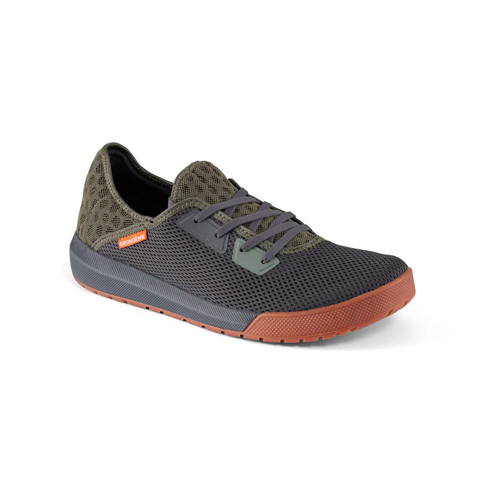 Grundens Keeper Sneaker featuring breathable mesh upper in black and olive green with gray laces and a textured rust-colored rubber sole, designed for comfortable outdoor use.