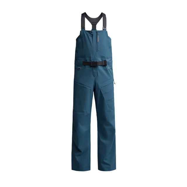 Sitka CAT-5 Bib in deep teal color, waterproof fishing bib pants with adjustable shoulder straps and a black waist belt designed for comfort and protection during fishing activities.