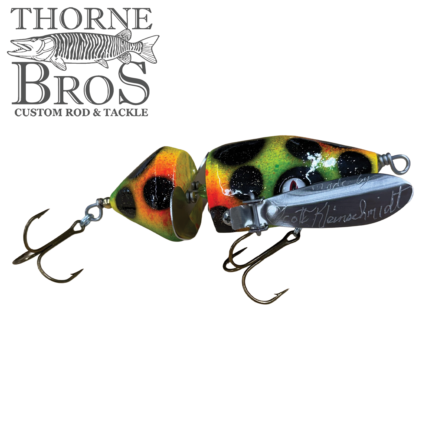 Musky Safari Mini Baby Spitzer fishing lure with segmented body in yellow, orange, and black pattern, featuring two treble hooks and metal detail, ideal for fishing tackle.