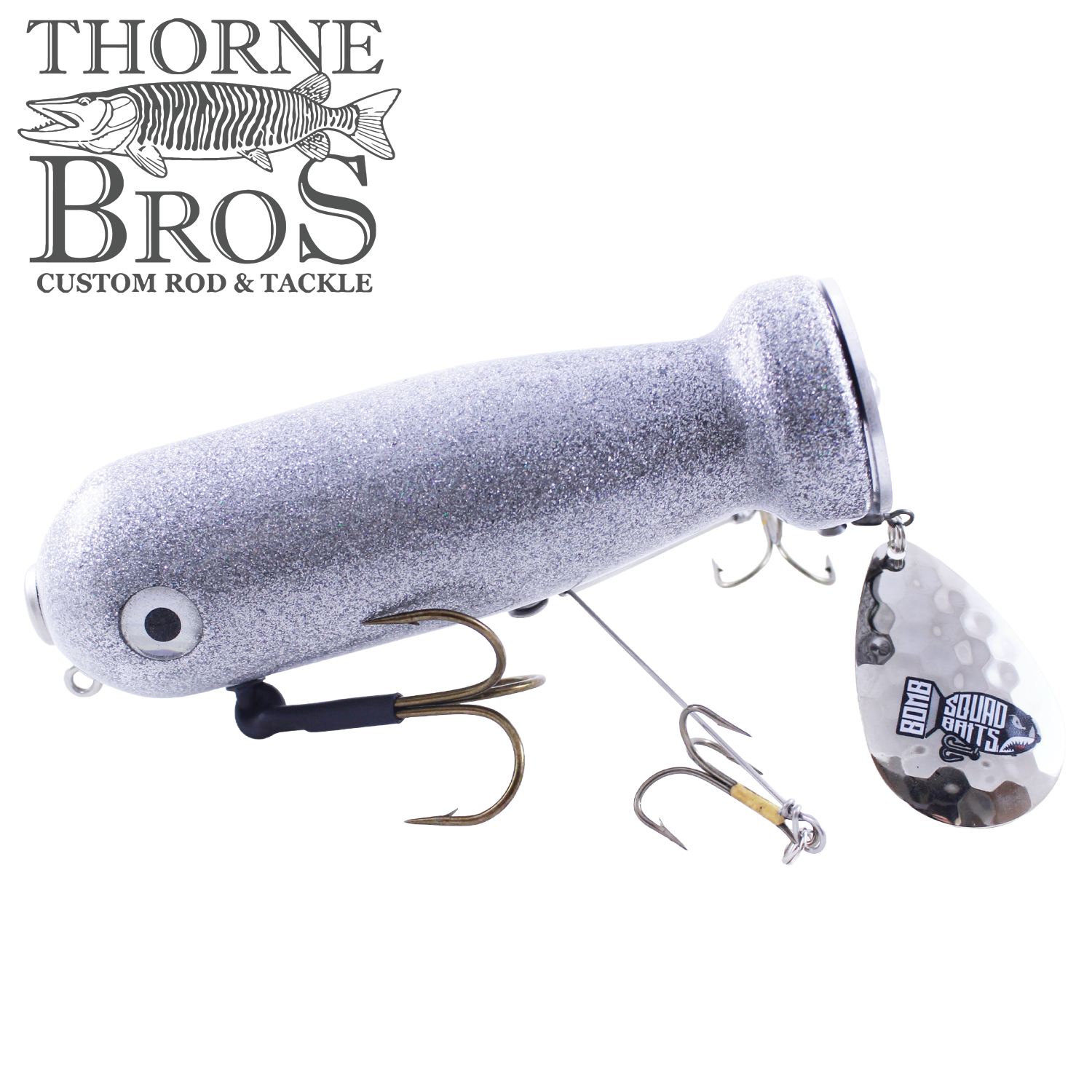 Bomb Squad MK-65 Flap Tail fishing lure in silver with dual treble hooks and a hammered metal spinner blade, designed for effective musky fishing tackle.