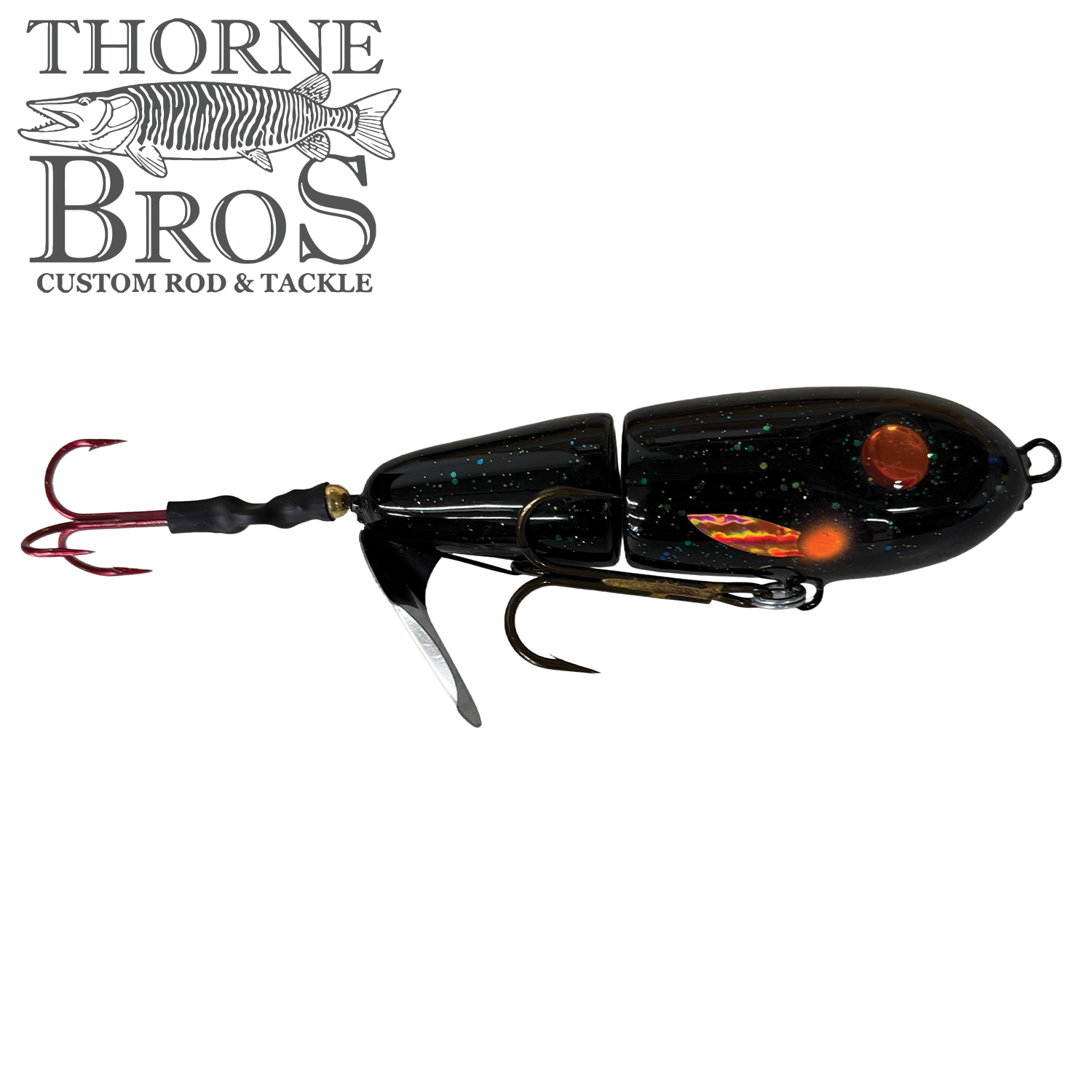 Detailed image of the Lake-X Dr. Evil fishing lure in black with glitter, featuring two treble hooks and segmented body designed for musky fishing, offered by Thorne Bros.