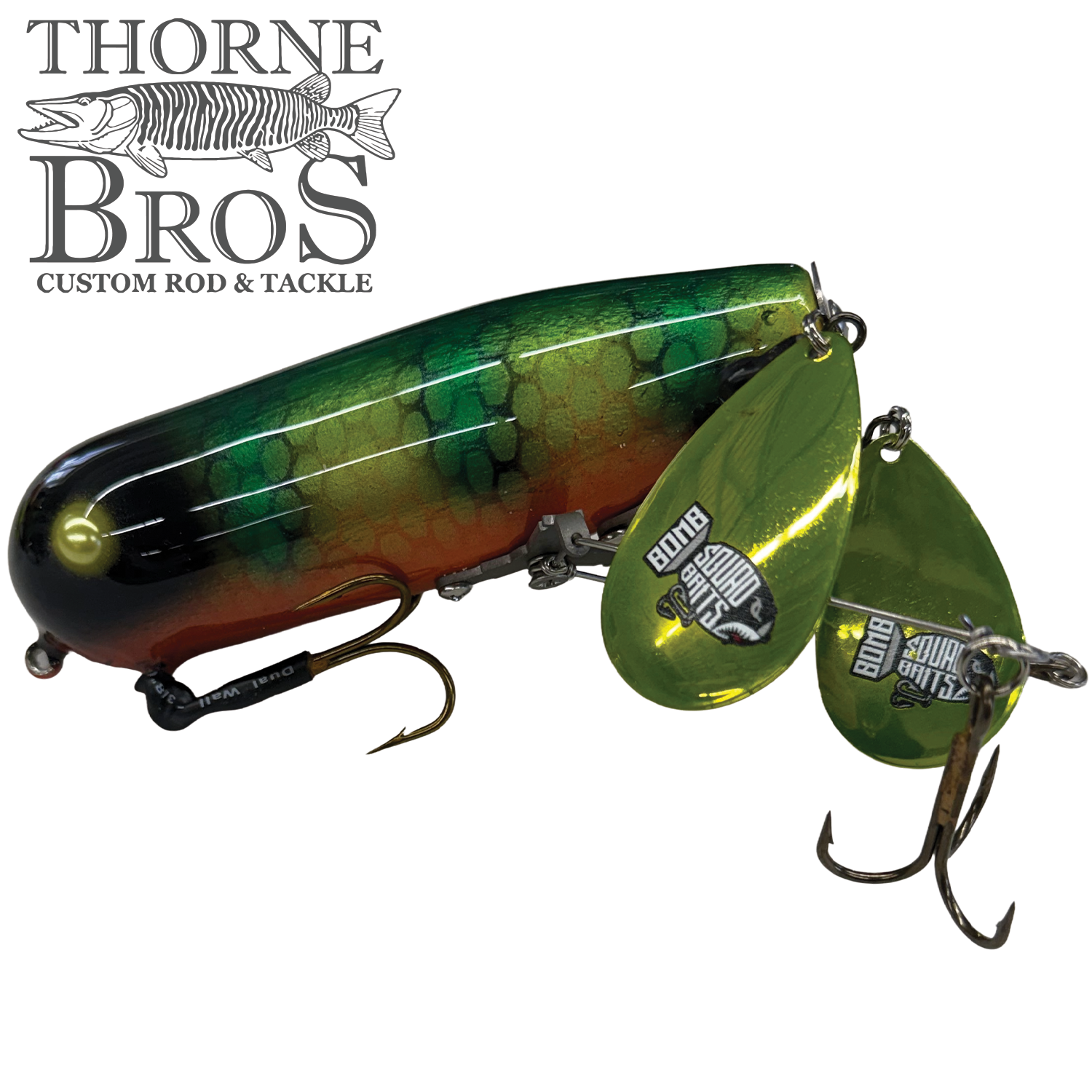 Bomb Squad Double Tap Flap Tail fishing lure with green and orange patterned body, two reflective green flaps, and sharp metal hooks designed for musky fishing.