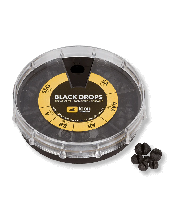 Loon Tin Drop Assortments featuring a round clear plastic container with compartments holding small black tin fishing weights in various sizes for precision fishing tackle use.
