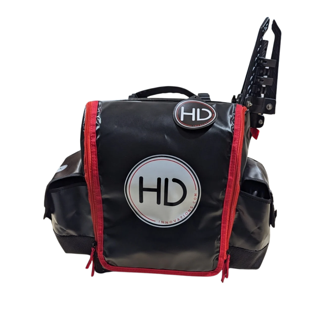 Black and red HD innovations XL Shuttle Bag with multiple compartments, side pockets, a top handle, and an attached rod holder for fishing tackle and gear storage.