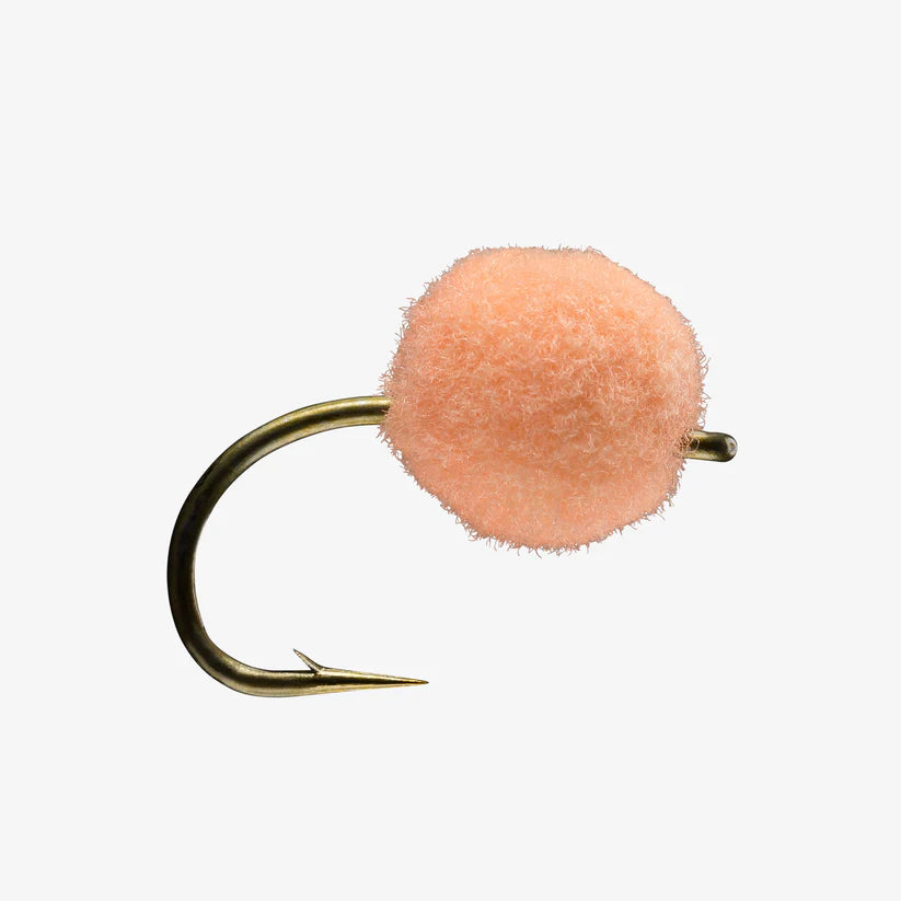 Close-up of an Egg Fly fishing lure with a peach-colored fuzzy egg-shaped body attached to a sharp gold-tone hook, designed for freshwater fishing tackle.