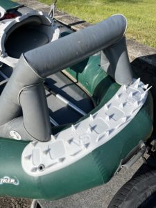 Scientific Anglers Launch Pad mounted on green inflatable fishing float tube with multiple rod holders and padded seat for comfortable musky and fly fishing.