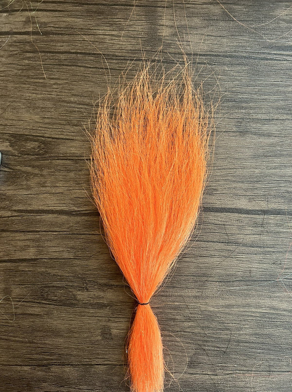 Bright neon orange synthetic fibers tied at the base, designed for use as a fishing lure component in the Squimpish Sparkle Blend for musky and fly fishing tackle.