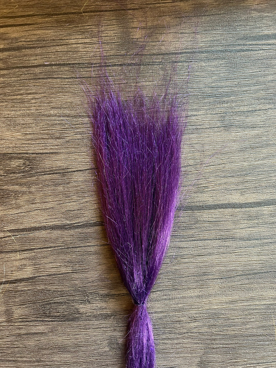 Squimpish Sparkle Blend showing a bundle of vibrant purple synthetic fibers with subtle shimmer, designed for creating custom fishing lures and tackle.