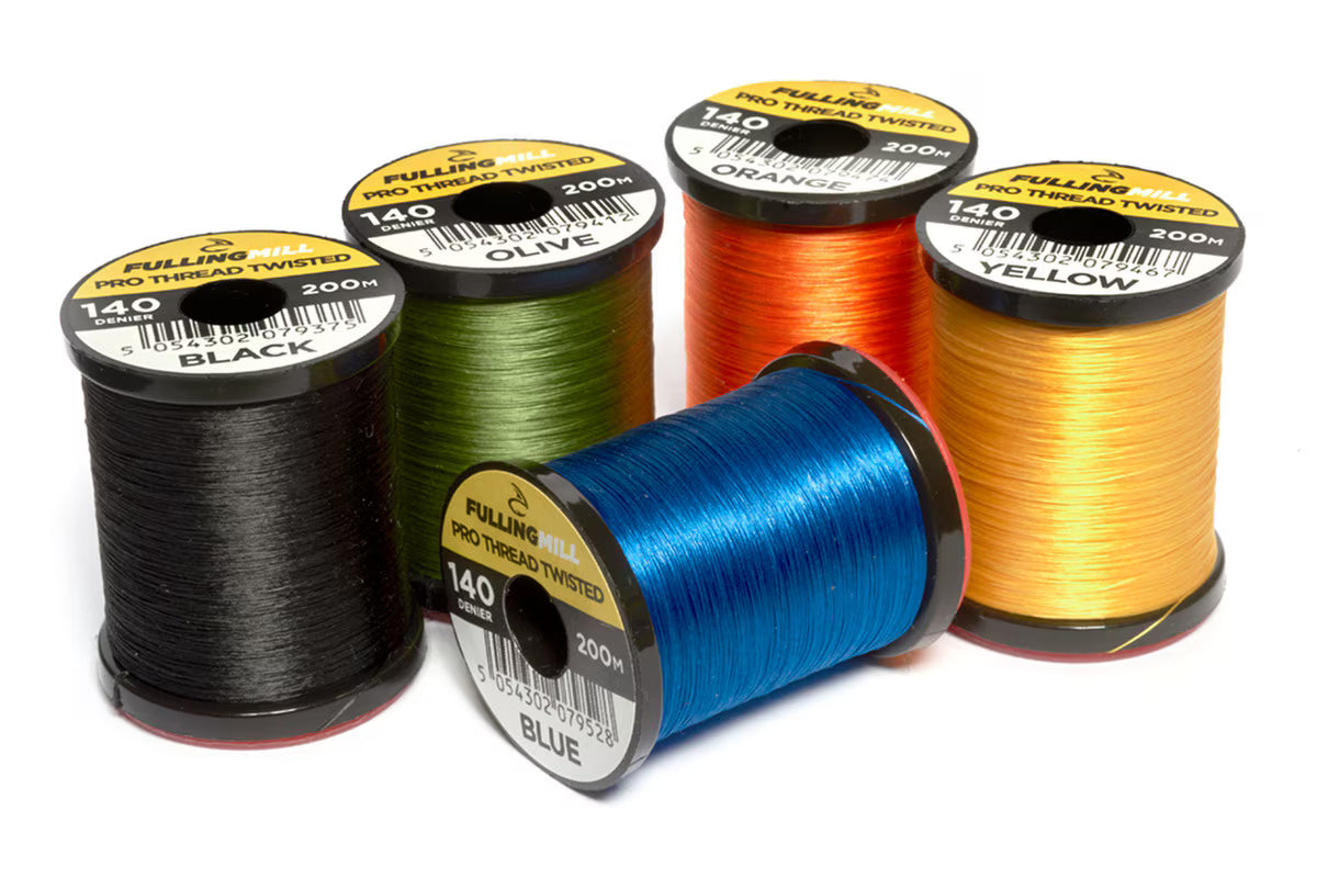 Four spools of Fulling Mill Pro Thread Twisted 140 Den in black, olive, blue, orange, and yellow colors, used for tying fishing lures and tackle.
