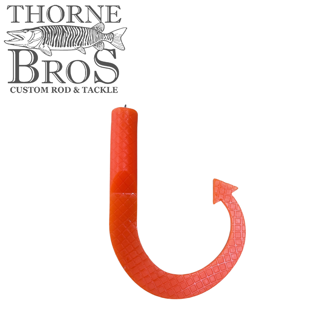 Single bright orange Boss Shad Hybrid Tails fishing lure with textured, curved tail designed for lifelike movement, displayed against a white background with Thorne Bros logo.