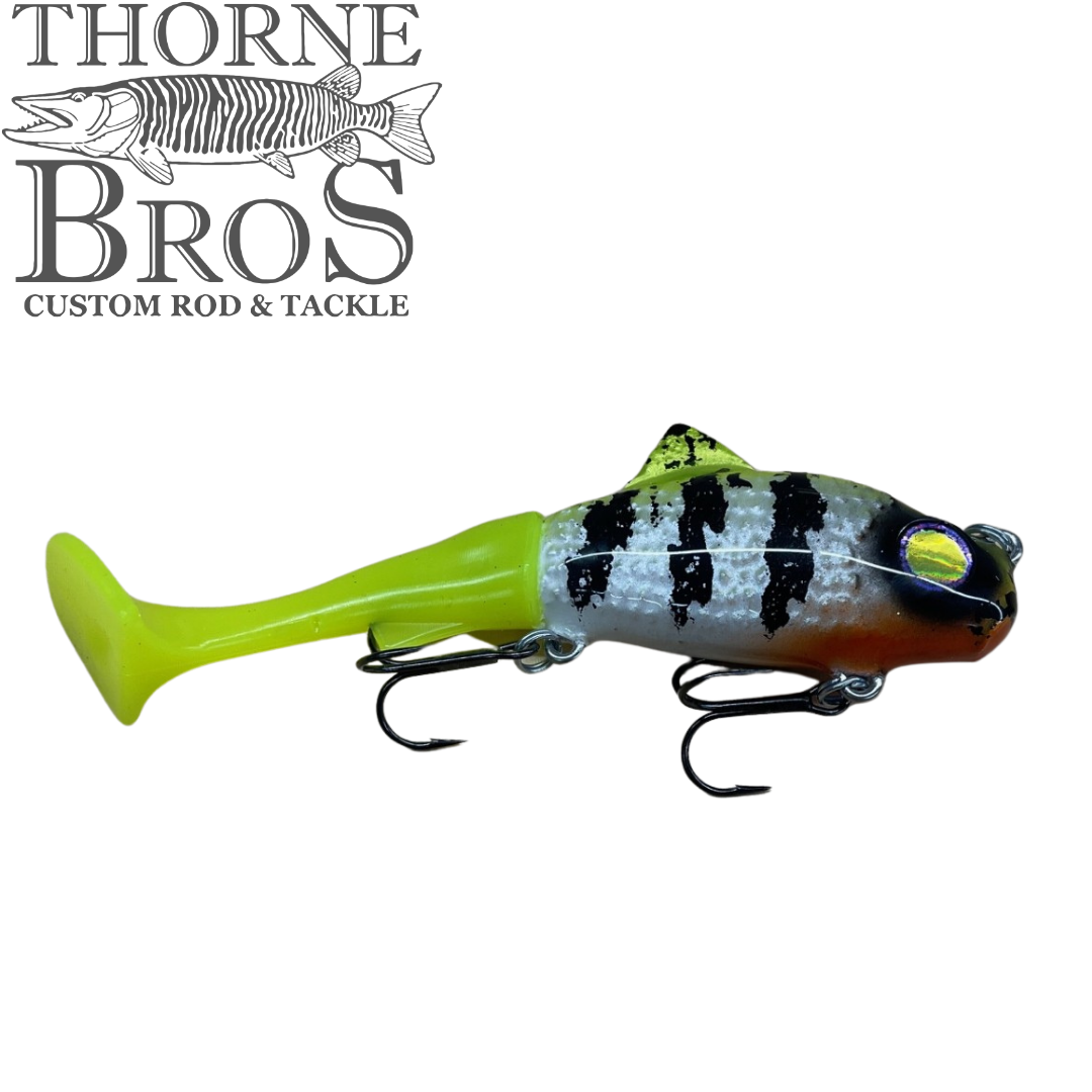 Zilla Baits TicTak musky fishing lure with a silver black striped body bright chartreuse tail and two treble hooks displayed with Thorne Bros branding