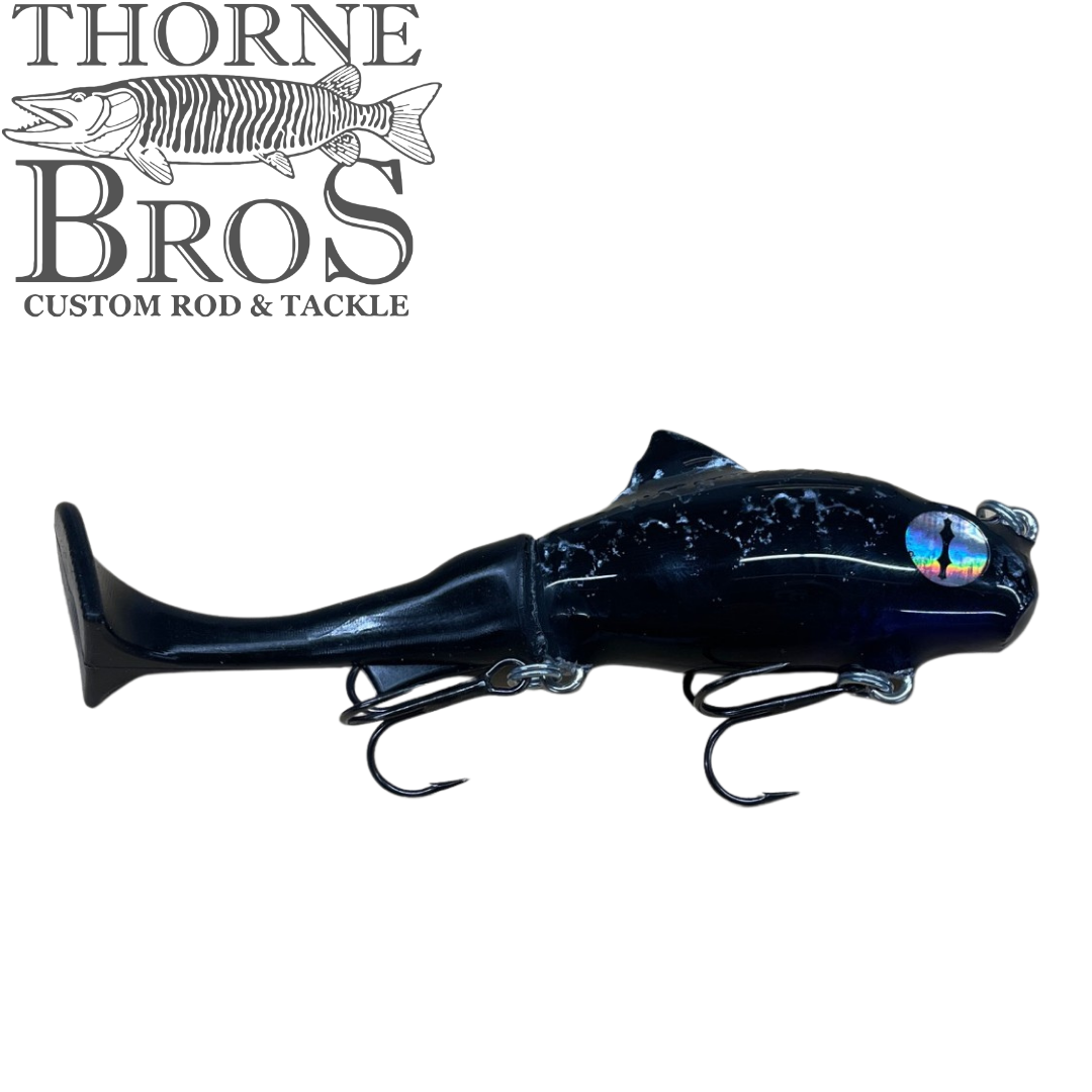 Zilla Baits TicTak black fish shaped musky fishing lure with reflective eye and two hooks displayed on a white background