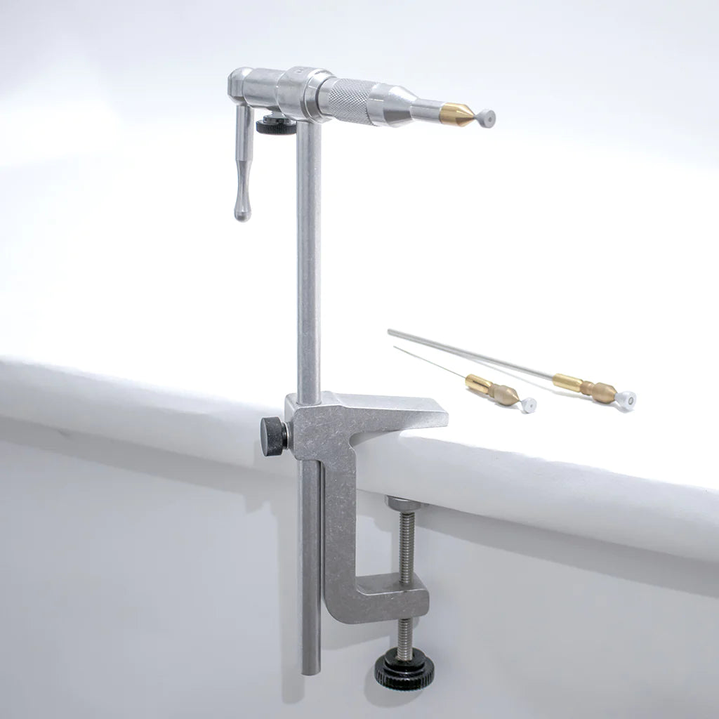 Renzetti Tube Fly Vise C-Clamp made of metal with adjustable clamp for mounting on a surface, featuring a rotating vise head and two brass fly tying needles.