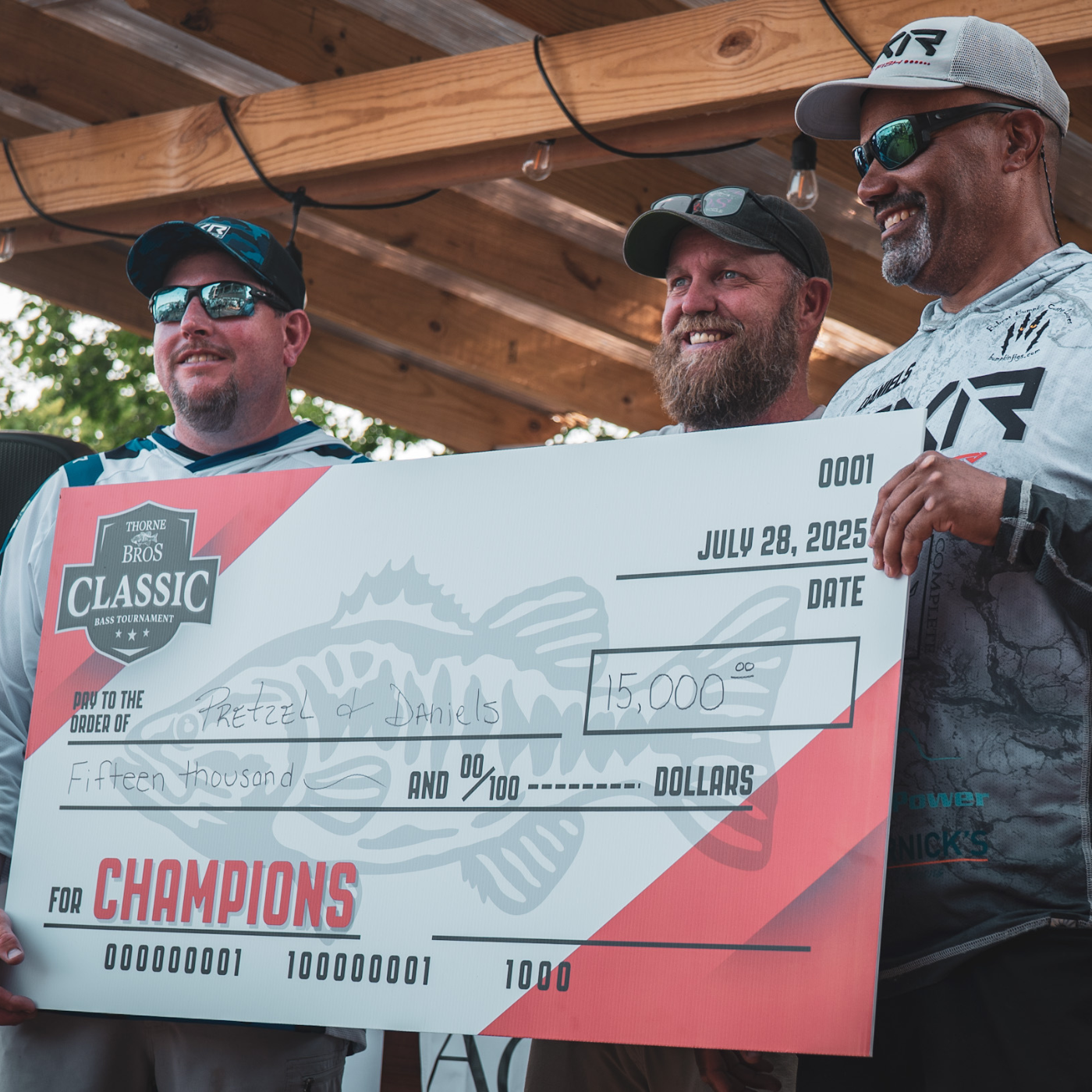 bass champions holding check