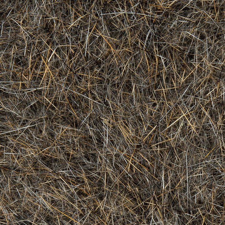 Close-up view of natural textured fibers in brown and tan shades used in Wapsi Natural Fur Dubbing for fly fishing lure and tackle creation.