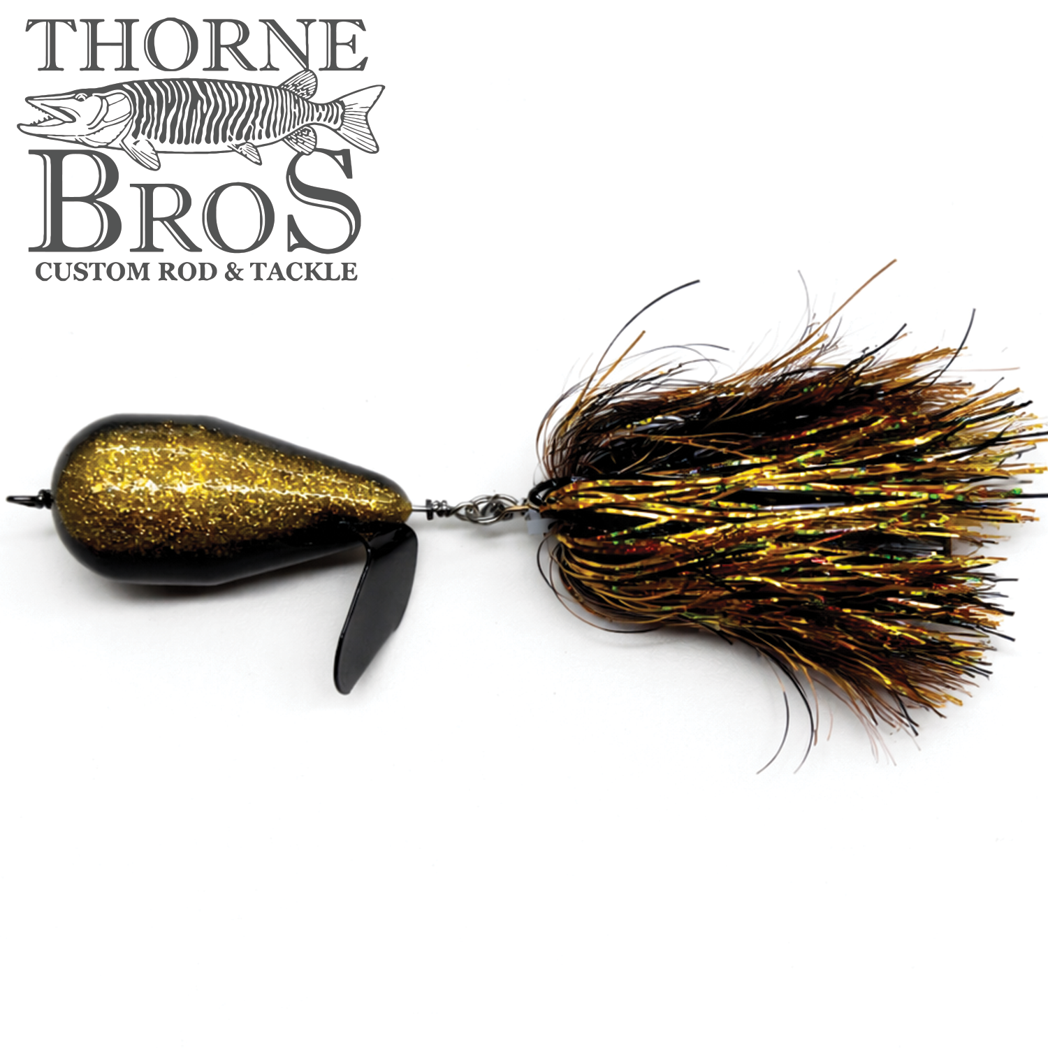Spanky Baits Violence fishing lure with a black and gold glitter body, featuring a propeller blade and a skirt of shimmering, iridescent fibers for musky fishing.