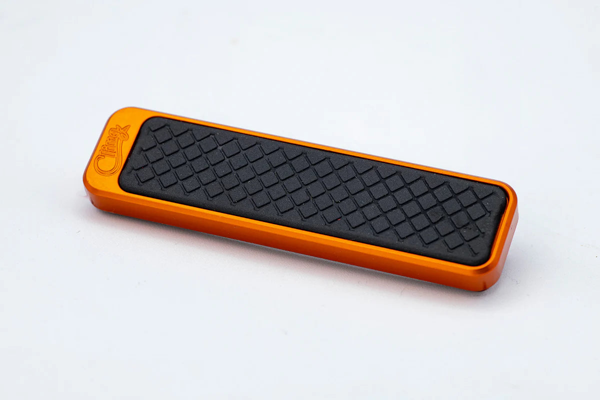 Cling Tool Stick Mini in bright orange with textured black grip surface, designed as a compact fishing tackle accessory for easy handling and secure grip.