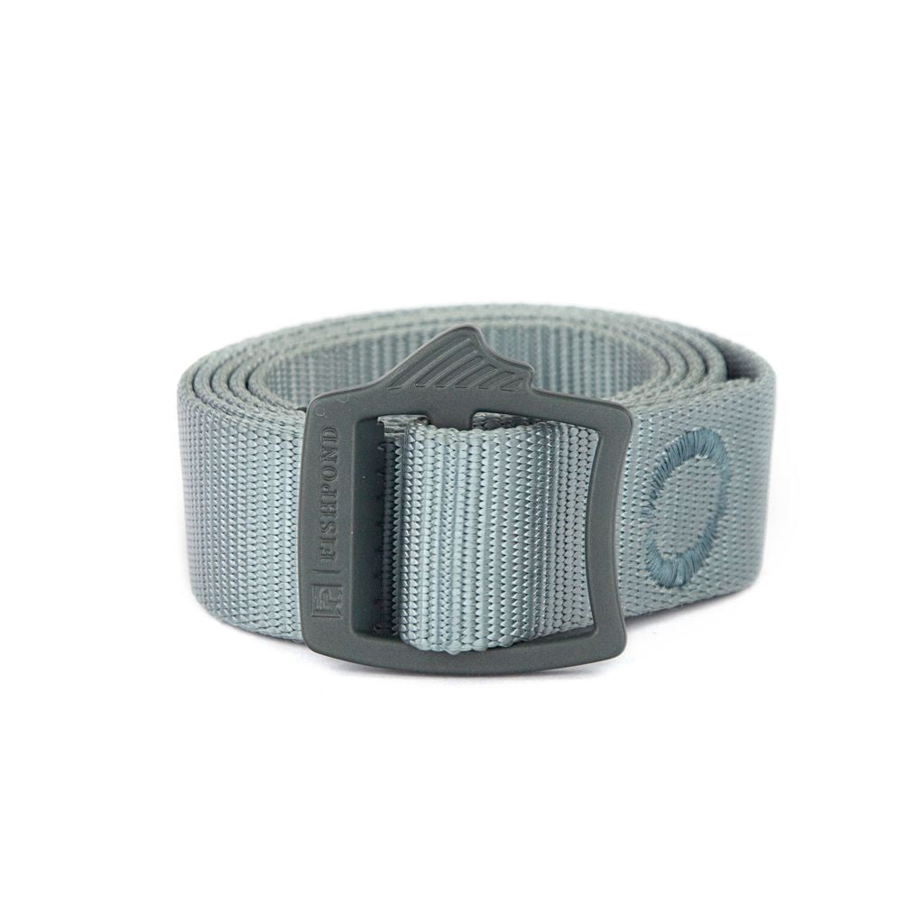 Fishpond Webbing Belt in gray with durable woven nylon material and a sturdy black buckle, designed for outdoor use and fishing tackle convenience.