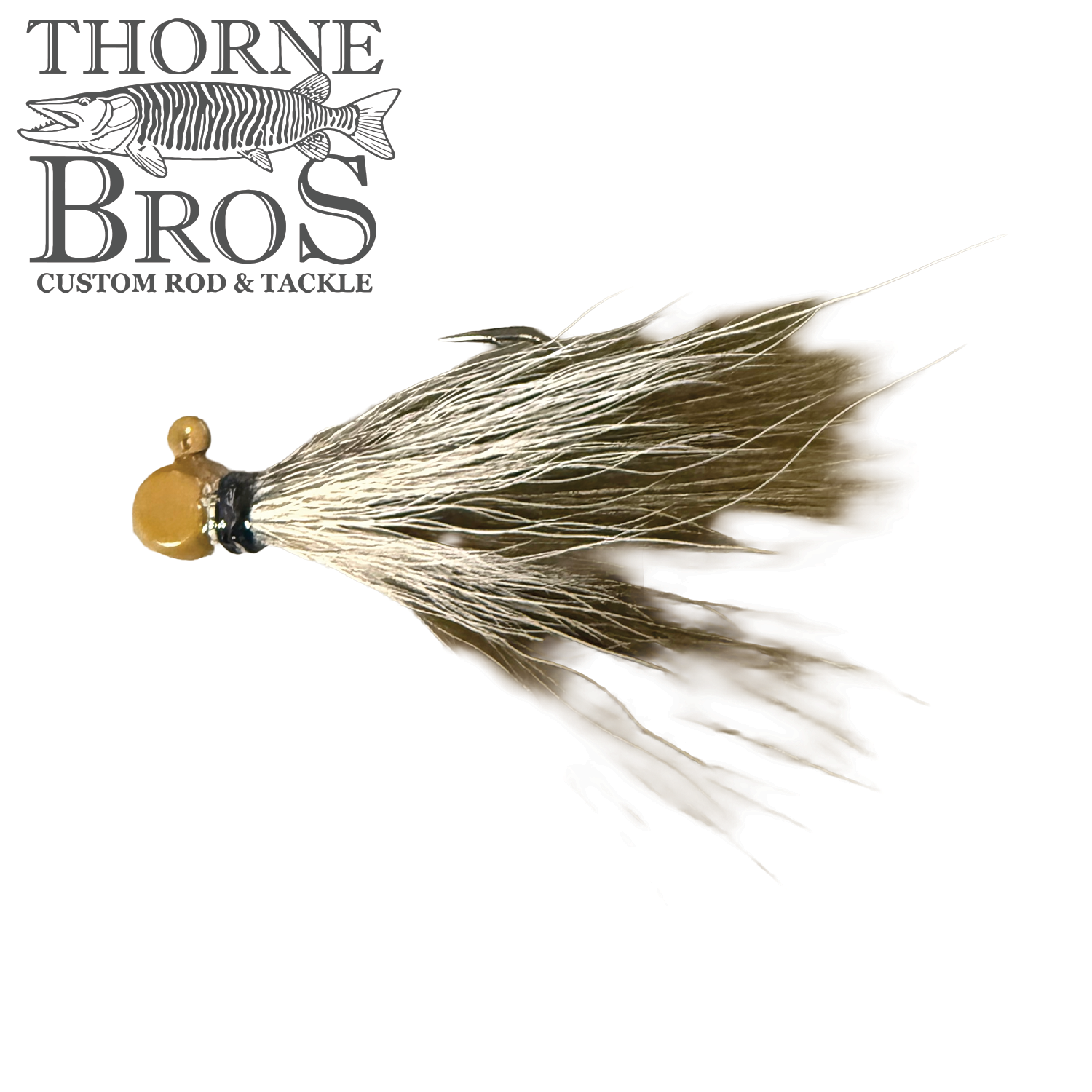 Thorne Brothers Hair Jig - Finesse features a small, detailed fishing lure with a gold-colored jig head and natural, flowing hair strands designed for finesse fishing techniques.
