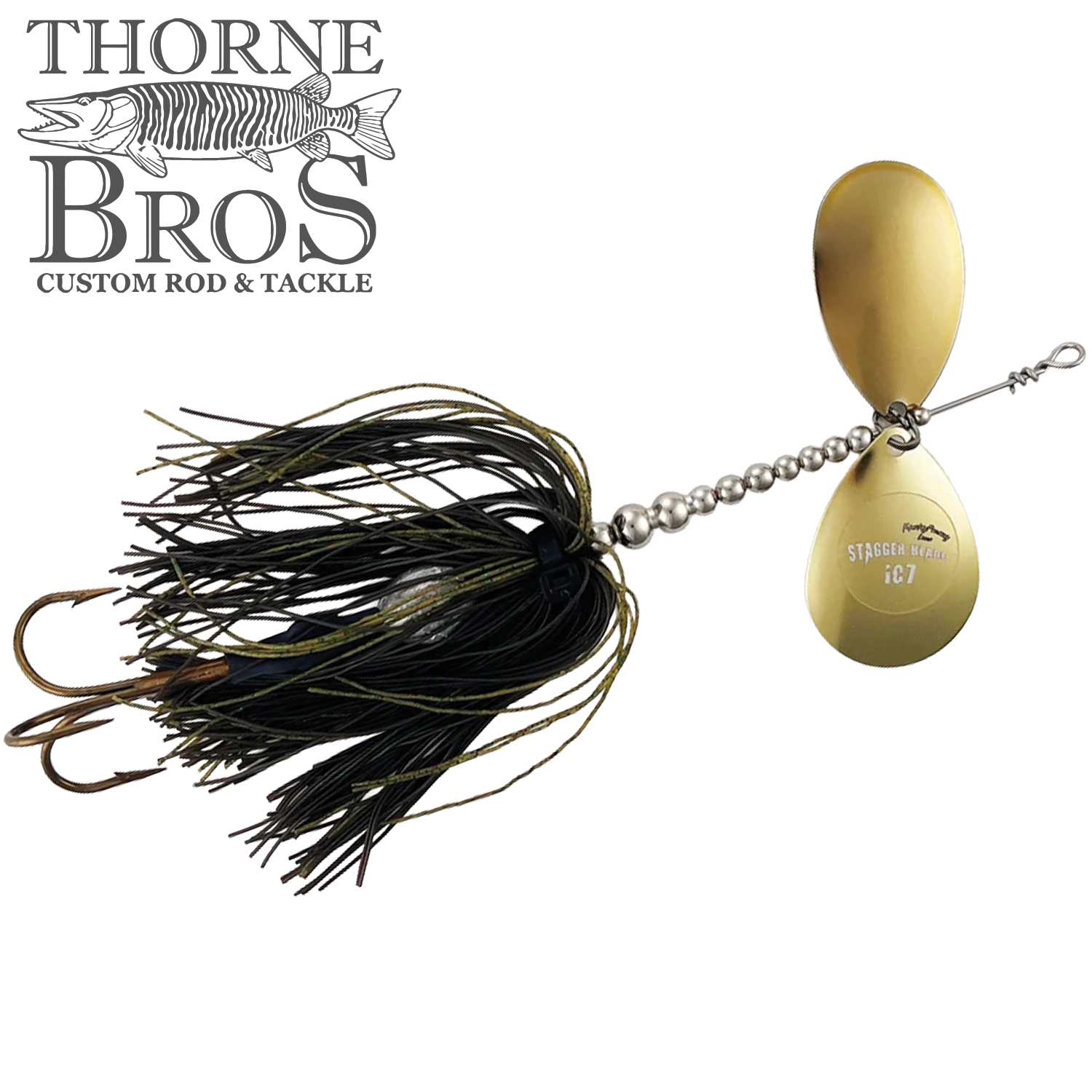 Musky Frenzy Apache Stag IC7 spinnerbait featuring dual gold blades, black and olive skirt, and sharp brown treble hooks designed for musky fishing tackle.