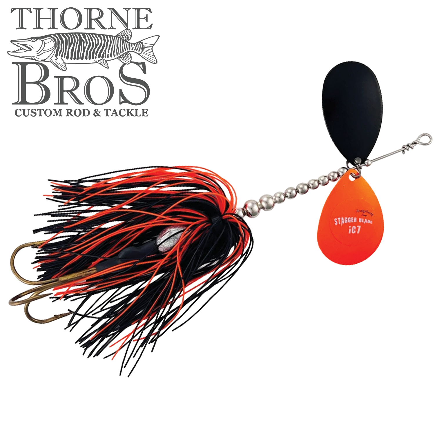 Musky Frenzy Apache Stag IC7 fishing lure with black and red silicone skirt, silver bead chain, double bronze hooks, and dual spinner blades in black and orange for musky fishing.