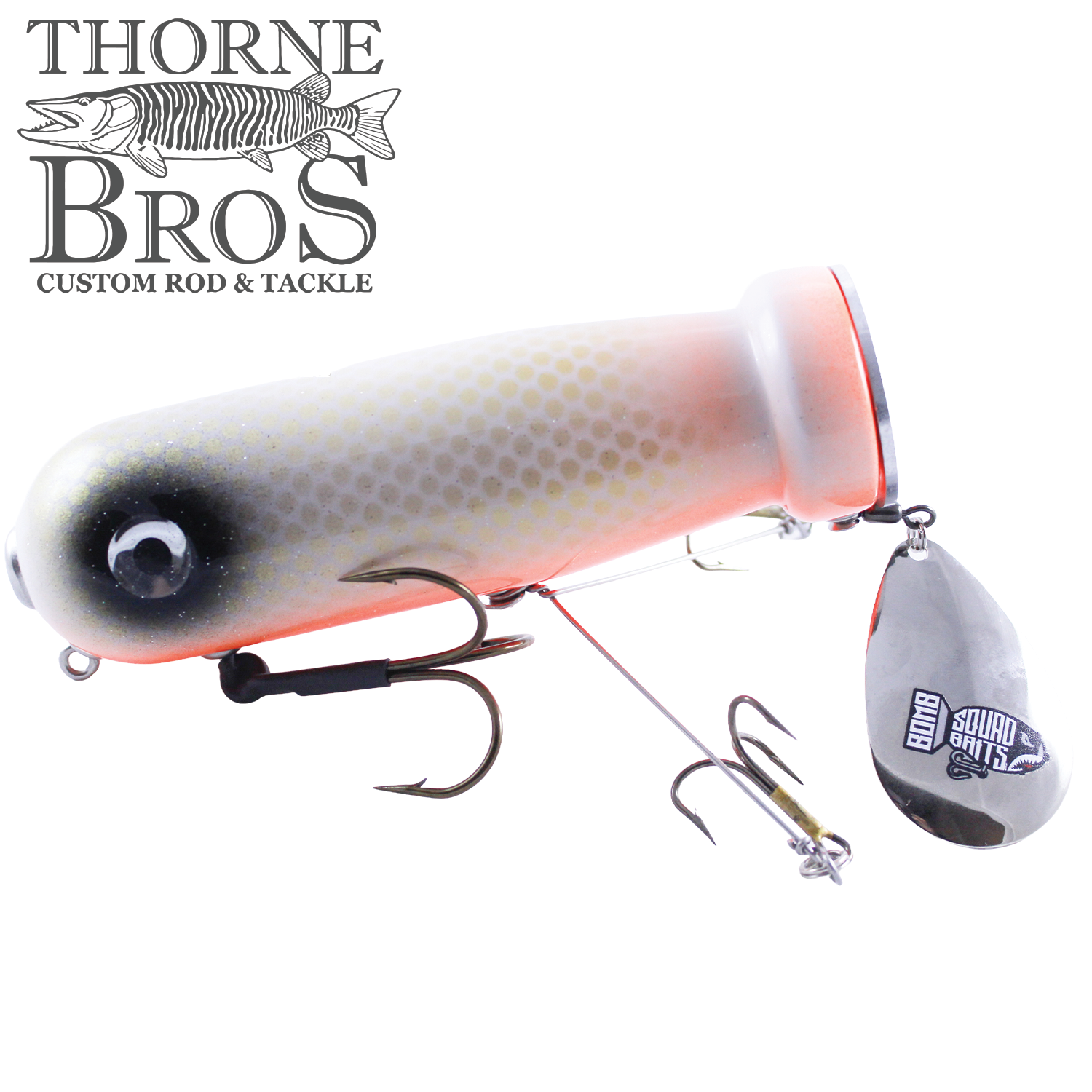 Bomb Squad MK-65 Flap Tail fishing lure with a white and gray body, black eye pattern, treble hooks, and a silver spinning blade for musky fishing tackle.