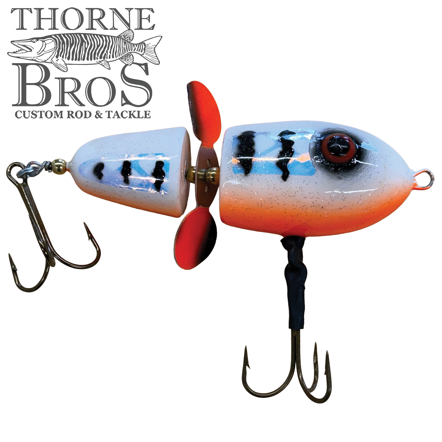 Lake-X Hammer fishing lure with segmented white and orange body, black stripes, red propeller, and two sharp treble hooks designed for musky fishing.