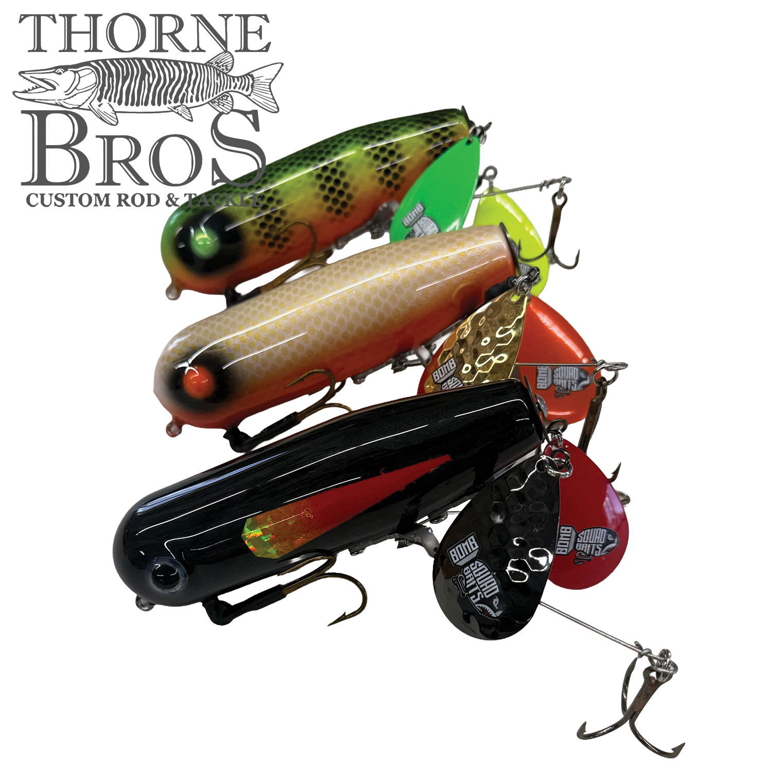 Four detailed fishing lures in various colors including green, orange, yellow, and black, each with multiple hooks and metal flap tails, labeled as Bomb Squad Double Tap Flap Tail.