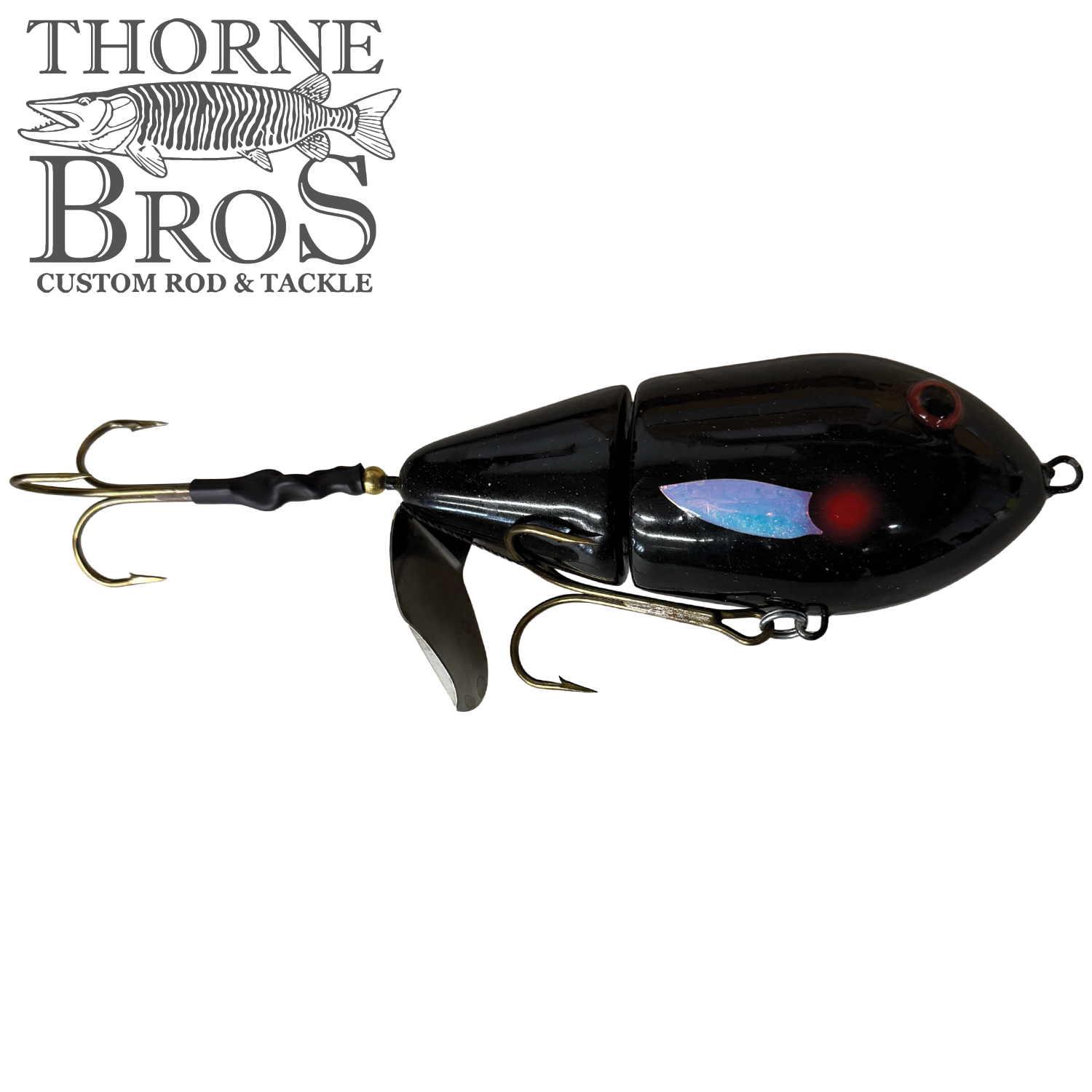 Black segmented musky fishing lure with three treble hooks and a small metal propeller, designed as Lake-X Cannonball JR. for use with fishing tackle.