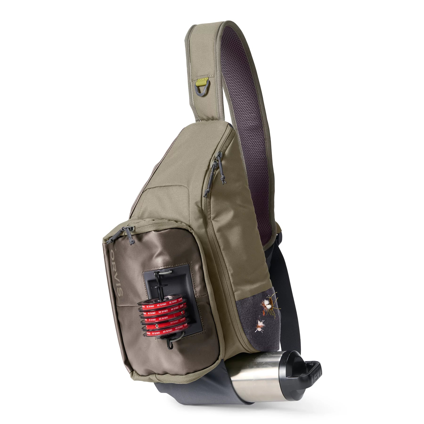 Orvis Sling Pack in olive and brown tones with multiple zippered compartments, featuring a front fishing line spool holder and a side mesh pocket, designed for convenient fishing tackle storage.