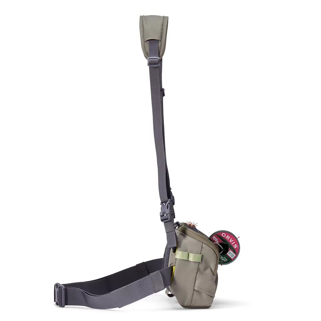 Orvis Chest/Hip Pack in olive green with adjustable shoulder strap, waist belt, buckle closures, and compact storage for fishing essentials