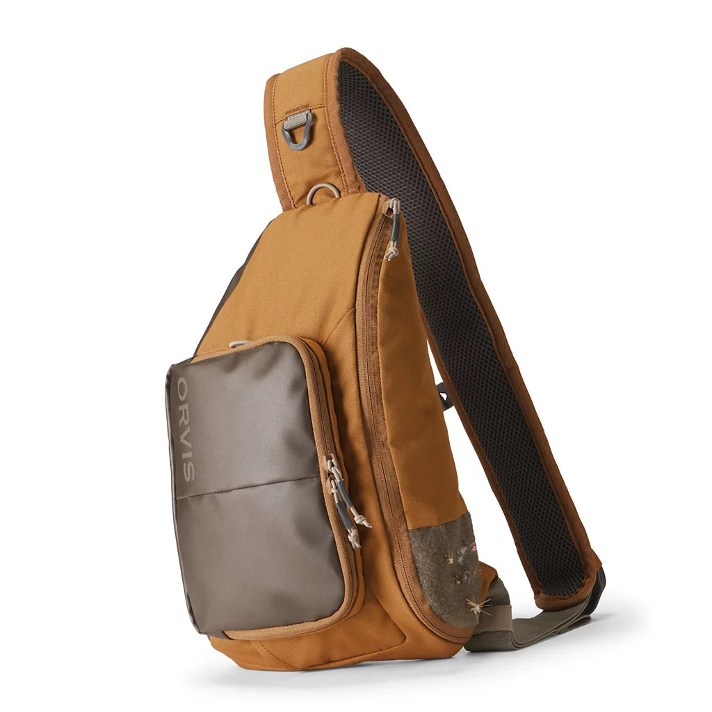 Orvis Mini Sling Pack in brown and gray with adjustable shoulder strap padded back panel and zippered compartments for organizing fishing tackle